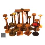 A pair of 1920s Liberty style oak stands each with pierced columns on square bases and assorted