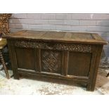An 18th Century carved oak coffer, the triple paneled top over lozenge detail front on stiles,