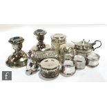 A small parcel lot of assorted silver items to include a pair of squat candlesticks, mustard pot,
