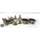 A pair of hallmarked silver Arts and Crafts oval open twin handled salts, Birmingham 1904, with