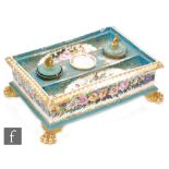 A 19th Century French porcelain Sevres style desk stand of rectangular form, raised on four gilt paw