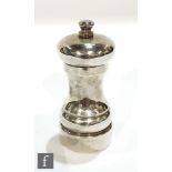 A modern hallmarked silver pepper mill of typical plain waisted form, height 10cm, London 1991.