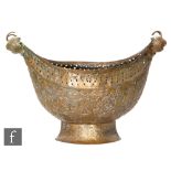 A late 19th to early 20th Century Persian hammered copper Kashkul (beggars bowl), the pierced oval