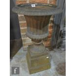 A Victorian cast iron campana shaped terrace urn on stepped plinth base, S/D, height 66cm.