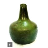 A late 17th and early 18th Century olive green onion bottle, height 17cm, A/F, with a similar wine