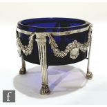 A 19th Century French silver circular bon bon dish with central blue glass liner, raised on four