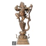A 19th Century Sino-Tibetan copper alloy or bronze shrine of a dancing Ganesha, raised on a double