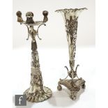 A pair of Chinese silver trumpet vases with applied floral decoration and raised to a triform base