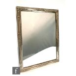 A 19th Century Austrian silver framed table mirror with part embossed foliate decoration to a wooden