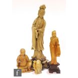 A collection of Chinese soapstone figures, to include a standing Guanyin figure raised on a lotus