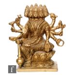 A Tibetan gilt metal Avalokitesvara shrine, the multiple headed deity raised on a double lotus base,