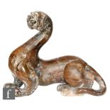 A Chinese green hardstone figure of a chilong, modelled in recumbent position with curled tail,