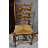 A set of six ash and rush seat ladder back dining chairs on turned legs and stretchers. (6)