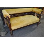 A late Victorian walnut two seater spindle back settee on turned legs upholstered in gold plush,