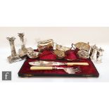 A small parcel lot of assorted hallmarked silver items to include a pair of candlesticks, a cream