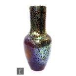 An iridescent earthenware Delphin Massiér vase, circa 1900, of tapered ovoid form rising to a