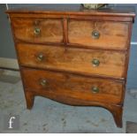 A George III mahogany straight front chest of two short and two long drawers, circular brass drop