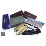 A Watermans Ideal 18ct gold nib fountain pen, two cased Parker pen sets, a gold coloured Parker ball
