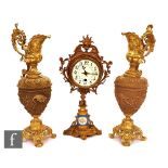 A 19th Century mantle clock with gilt metal case around a white metal dial, mounted to a gilt