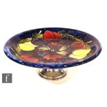 A Moorcroft cake plate decorated in the Wisteria pattern, raised to a chrome stand, impressed marks,