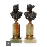 A pair of late 19th to early 20th Century French bronze classical busts, each on an onyx base, one