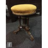 A Victorian circular piano stool upholstered in gold plush and a near pair of buttoned leather piano