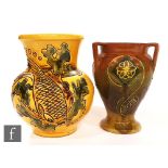 Two early 20th Century C.H Brannam, Barnstaple vases, the first decorated with an incised fish