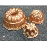 Three Victorian copper jelly moulds, diameter of largest 27cm.