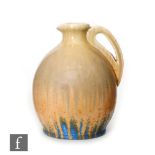 A Ruskin Pottery crystalline glaze jug decorated in a mustard yellow to orange to blue, impressed