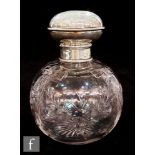 An early 20th Century Stourbridge clear crystal scent bottle of spherical form decorated with
