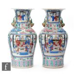 A pair of late 19th Century Chinese Canton famille rose vases, each of baluster form, extending to a