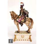 An Italian model of a Hussair on horseback, raised to a shaped rectangular plinth, indistinct