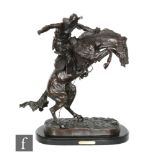 AFTER FREDERIC REMINGTON - 'The Bronco Buster', a contemporary bronze cast, bears signature, on