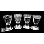 A near set of four penny lick glasses on ring turned stems and circular feet, height 9cm. (4)