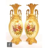 A pair of late 19th Century Austrian porcelain vases of footed ovoid form with high loop handles and