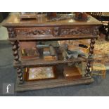 A Victorian carved dark oak two tier buffet with single frieze drawer below a marble top concealed