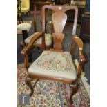 A set of eight 1920s Queen Anne style walnut dining chairs, each with a vase-shaped splat above a
