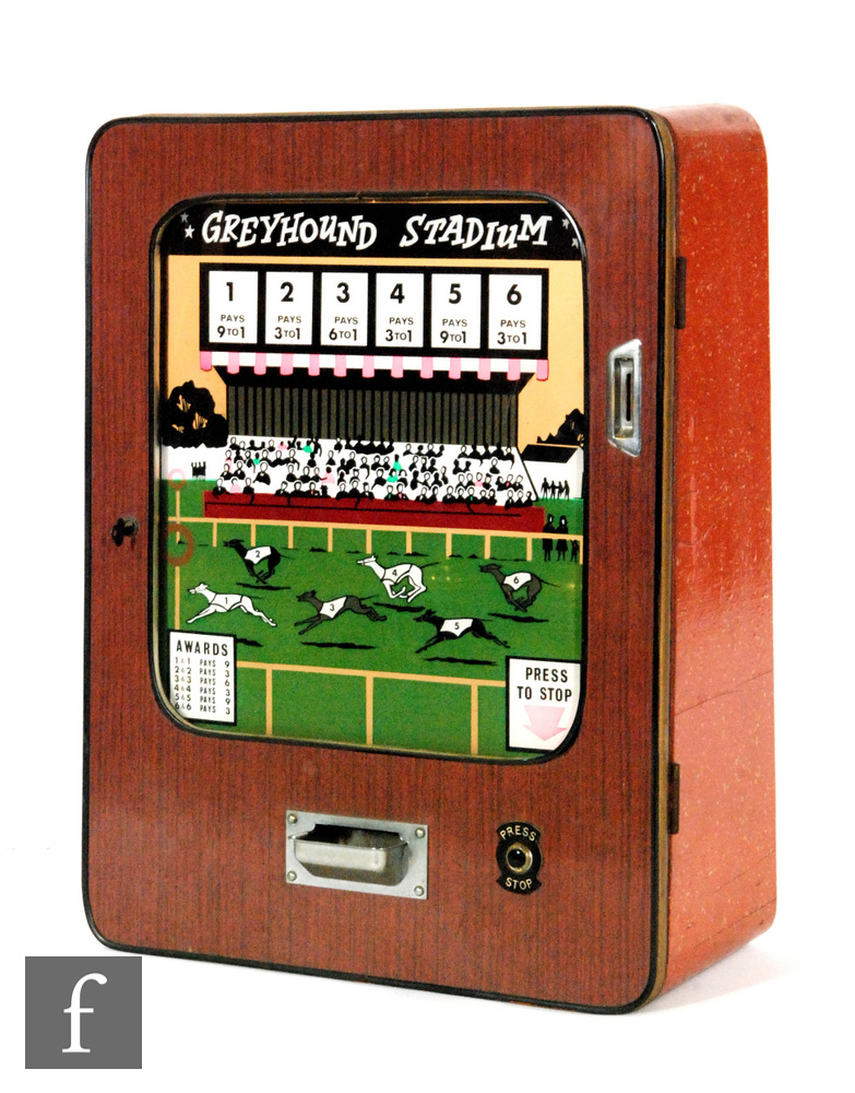 A 1970s wall mounted Greyhound Stadium penny slot machine, height 68cm, with key.