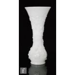 A Baccarat opaline glass vase, circa 1880, of footed globe and shaft form with flared rim, decorated