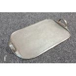 A Liberty & Co. Tudric pewter tray shaped oblong with twin loop handles issuing from shaped leaves