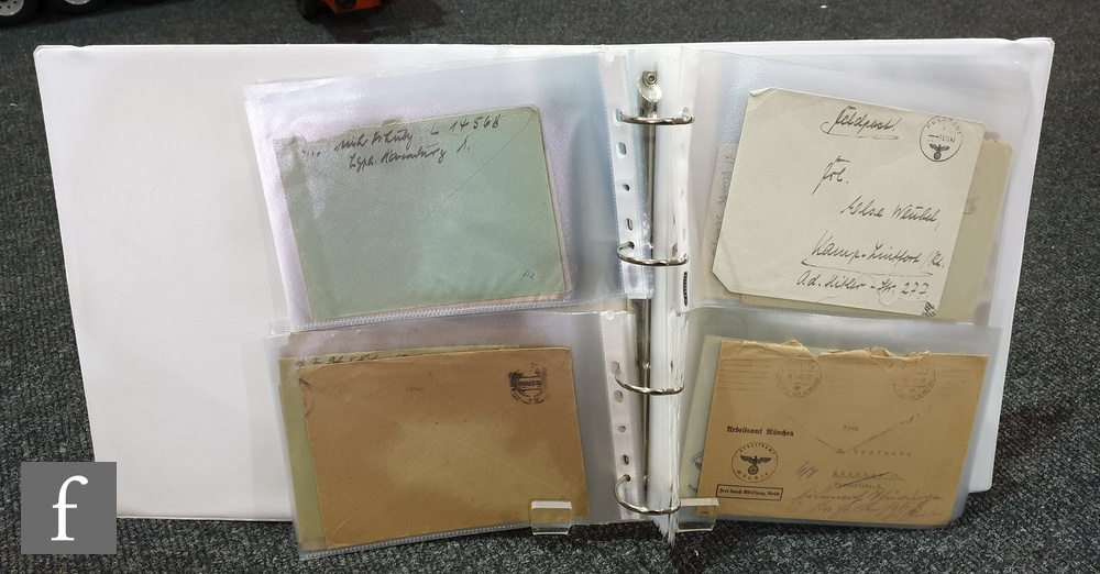 A white ring binder album containing sixty Second World War German soldiers 'Feldpost' covers,