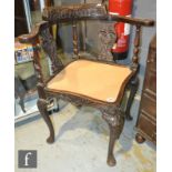 A Victorian carved oak corner chair on cabriole legs, an inlaid revolving piano stool and a small