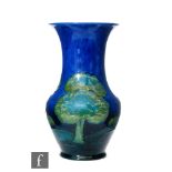 A William Moorcroft vase of flared baluster form decorated in the Moonlit Blue pattern with