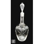 An early 20th Century clear crystal decanter of ovoid form with applied loop handle and white