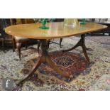 A Regency style cross-banded mahogany twin pillar dining table on splayed reeded legs, height 75cm