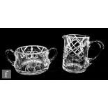 An early 20th Century American cream jug and twin handled sugar bowl, the clear glass with a