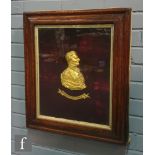 A 19th Century gilt metal side profile bust of Wellington, mounted on a red velvet back in