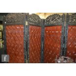 An early 20th Century carved ebonised folding dressing screen