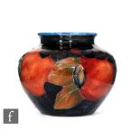 A small Moorcroft vase of ovoid form with a flared collar neck decorated in the Pomegranate