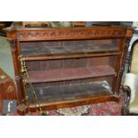 A Victorian figured walnut floorstanding open bookcase, the projected corners over a pierced